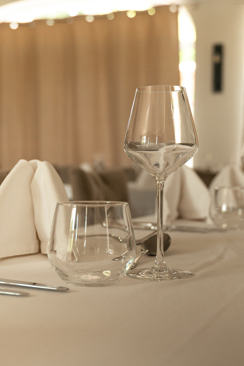 Le verre et les serviettes pliées, sur la nappe blanche