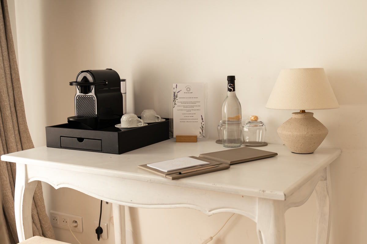 La console blanche, la machine à café et la carafe d'eau offerte